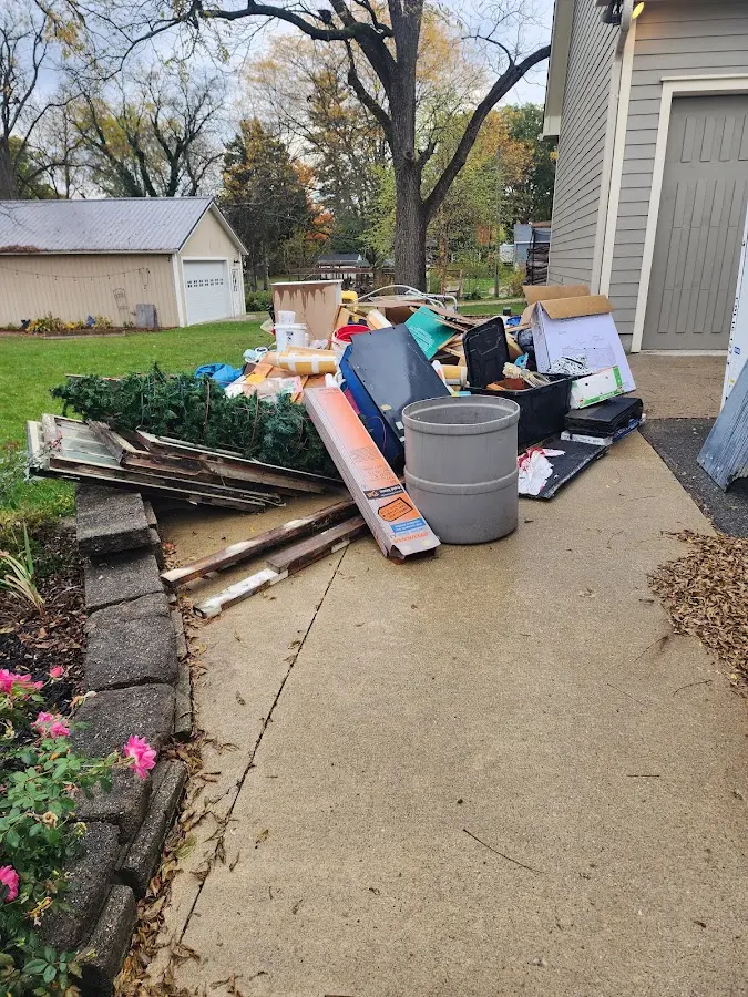 Dumpster being loaded with debris for 12 Yard Dumpster Rental in Crete